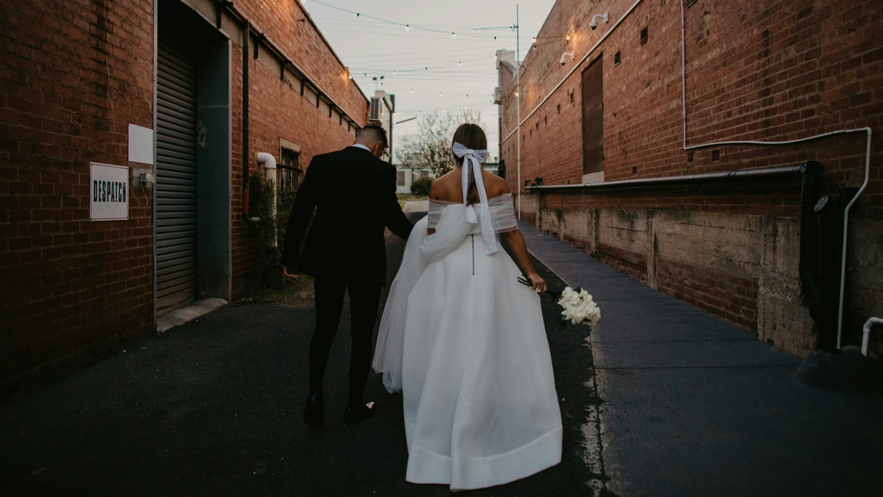 Wedding couple outside a warehouse alley.